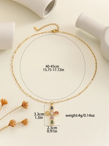 Detail shot of gold cross necklace with colorful zircon stones and size measurements