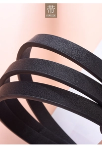 Macro shot of flexible black cowhide leather belt showing natural texture and soft grain