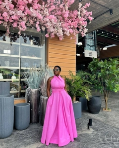 Detail of bright pink sleeveless maxi dress featuring shirt collar and button-up front