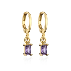 Macro shot of gold hoop earrings with rectangular purple zircon pendants and soft reflection