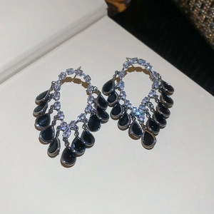 Detail of 18K gold plated silver stud earrings with black pear cut zircon stones