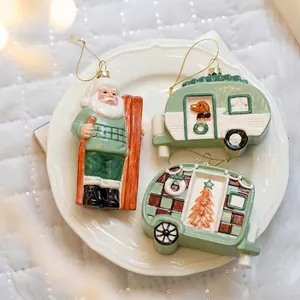 Three-piece ceramic Christmas ornaments set with Santa Claus and vintage camper trailers