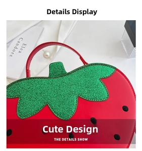 Detail shot of a creative red strawberry shoulder bag with green glitter leaf texture