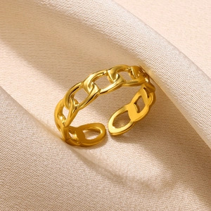 Close-up of golden chain link adjustable ring on champagne satin background
