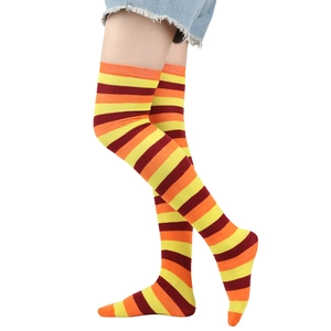 Detail of high-elasticity over-the-knee socks with yellow, orange, and red stripes