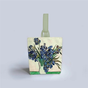 Detailed close-up of Irises painting print on a cream vintage-style bucket handbag