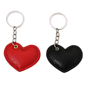 Set of red and black leather heart-shaped keychains with metallic rings on white background