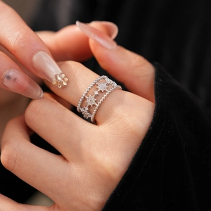 Close-up of double-layer star ring with cubic zirconia stones on model finger