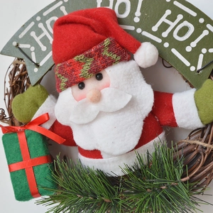 Christmas wreath with Santa plush doll, pine needles and HO HO HO decorative sign