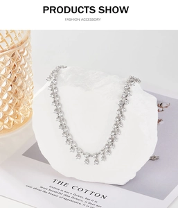 Detail showing a luxurious S925 silver necklace with zircons on a white stone background