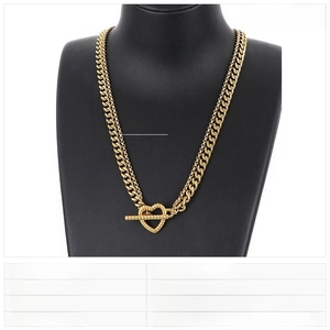 Detail of gold double-layer stainless steel chain necklace with heart toggle clasp