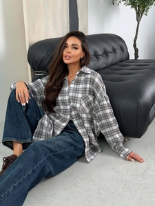Oversized brown plaid button-down shirt for women styled with wide-leg jeans
