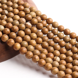 Detailed view of natural yellow wood grain stone beads for DIY jewelry making
