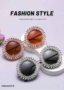 Close-up of sunflower-style rhinestone frames with pink and black gradient lenses