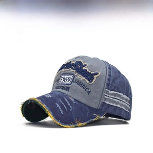 Detail of vintage washed denim baseball cap with 1969 embroidery and distressed edges