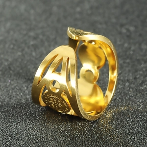 Macro detail of gold Saint Benedict medal ring with open band and hollow geometric patterns