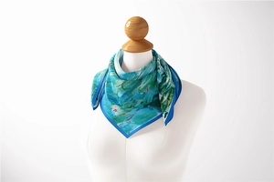 Detailed view of Monet oil painting silk scarf with water lily pattern on neck model