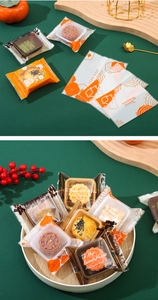 Detailed view of festive plastic mooncake packaging bags with colorful fruit props