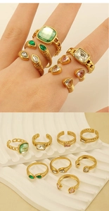 Detailed view of assorted gold rings featuring green, pink, and clear zircon gemstones