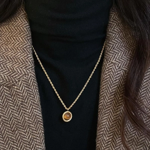Vintage round flower tiger eye pendant necklace on model with golden rope chain