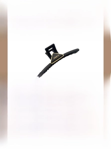 Detailed view of large black shark clip with copper gold plated POWER metal triangle