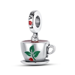 Macro detail of silver coffee cup charm with green leaves, berries and LOVE engraving