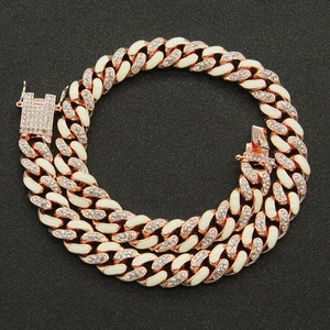 Detail of rose gold Cuban link necklace with white enamel and sparkling crystal pave