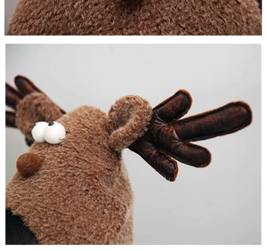 Close-up detail of plush reindeer Christmas hat with brown antlers and fabric texture