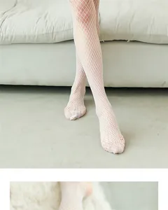 Detailed close-up of white ruffled fishnet stockings featuring medium-mesh knitted pattern