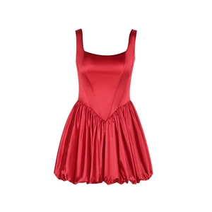 Detail of red satin mini dress featuring high-waisted bubble hem and glossy silk texture