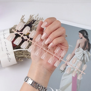 Long square glossy nude press-on nails set with UV top coat shown on hand in elegant scene