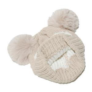 Close-up of knit texture and double plush pom-poms on the cream owl-themed baby hat