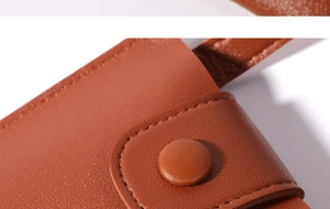 Macro shot of brown leather phone bag showing precise stitching and snap button closure