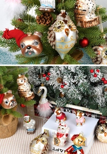 Close-up of painted glass Christmas ornaments showing owl and swan textures