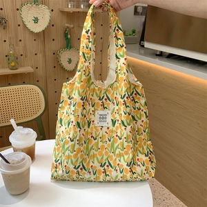 Dettaglio del motivo a tulipani e dell'etichetta Love su una borsa tote in tela