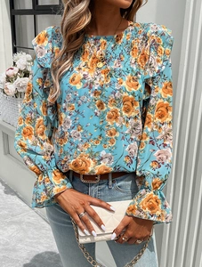 Detail of smocked collar and ruffle cuffs on women's floral long sleeve shirt