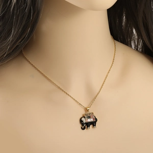 Close-up of golden necklace featuring a black elephant pendant with multi-color zircon stones