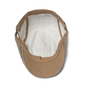 Internal structure of tan cotton beret hat showing lining and quality stitching