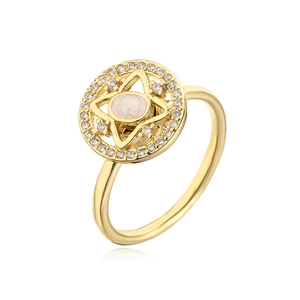 Macro detail of 18K gold plated ring featuring rotating zircon star and white oval stone