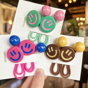Detail of high-elasticity hair ties with colorful smiley faces and decorative round beads