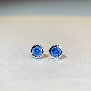 Minimalist S925 sterling silver stud earrings featuring round blue cubic zirconia