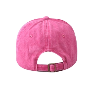 Detail of pink washed cotton baseball cap with adjustable brass buckle on back