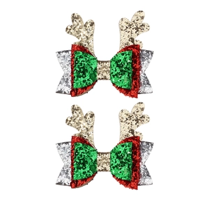 Detail of glitter Christmas hair clips with reindeer antlers and festive red bows