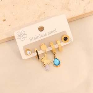 Trois paires de boucles d'oreilles en acier doré avec papillon et goutte bleue
