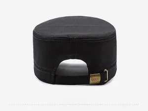 Detail of adjustable bronze metal buckle with Sport engraving on black canvas flat top cap
