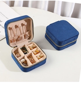 Macro shot of dark blue velvet jewelry box with internal slots for rings and necklaces