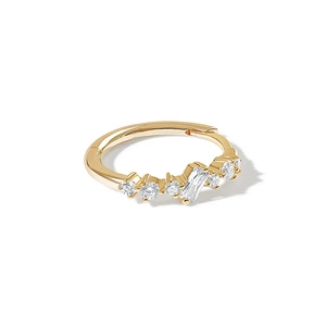 Detail of gold huggie hoop earring with mixed-cut sparkling CZ diamonds on white background