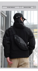 Detail of black geometric hardshell chest bag with 3D triangle pattern and branded tag