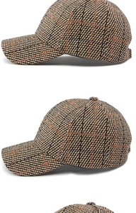 Detailed close-up of vintage plaid tweed texture on a structured baseball cap