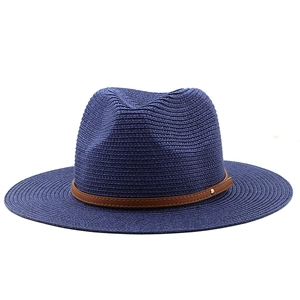 Detailed weave of a navy Panama hat featuring a brown leather strap and gold stud detail